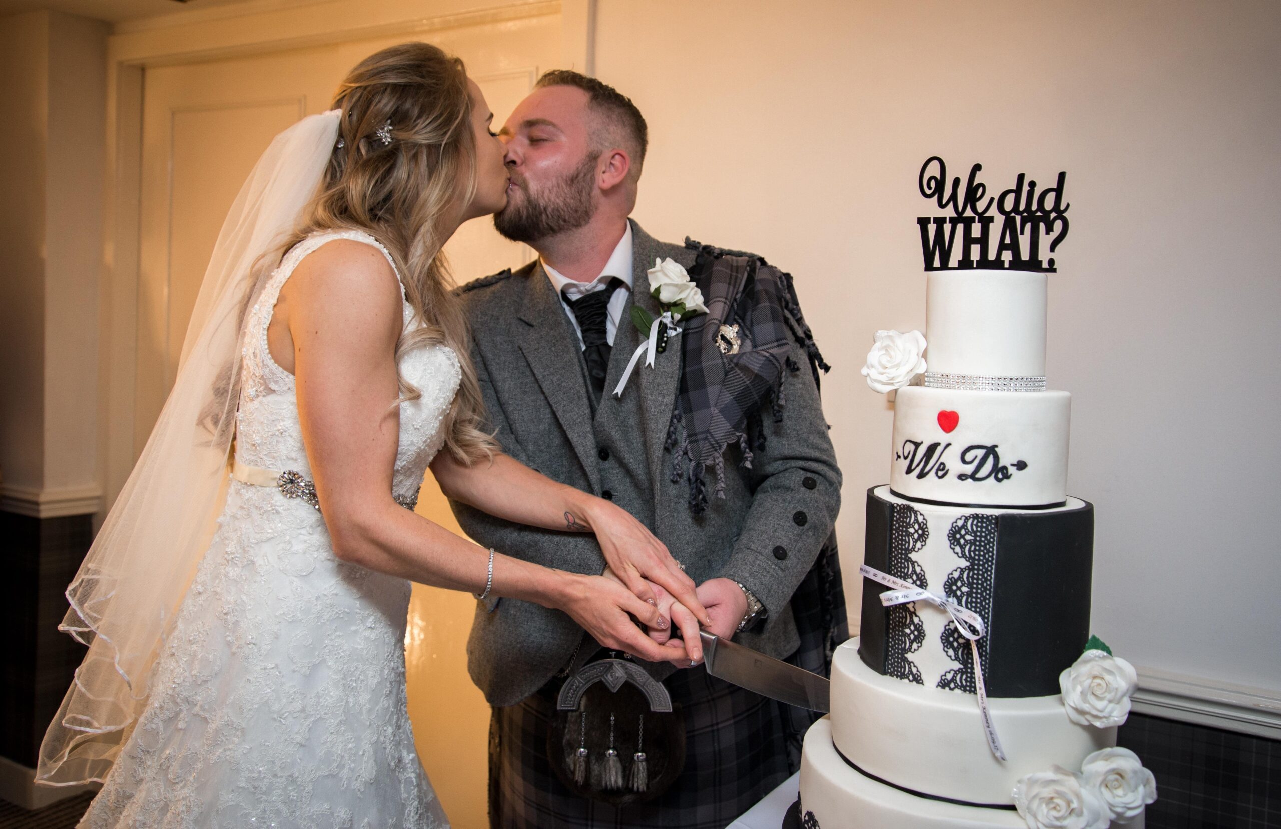 Scottish Couple cutting wedding cake