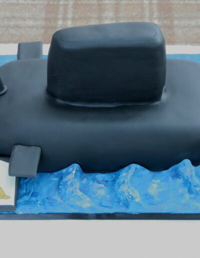Submarine shaped cake with waves and submariners emblem